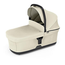 Soft beige Thule bassinet featuring a collapsible canopy and a secure harness for infant safety.