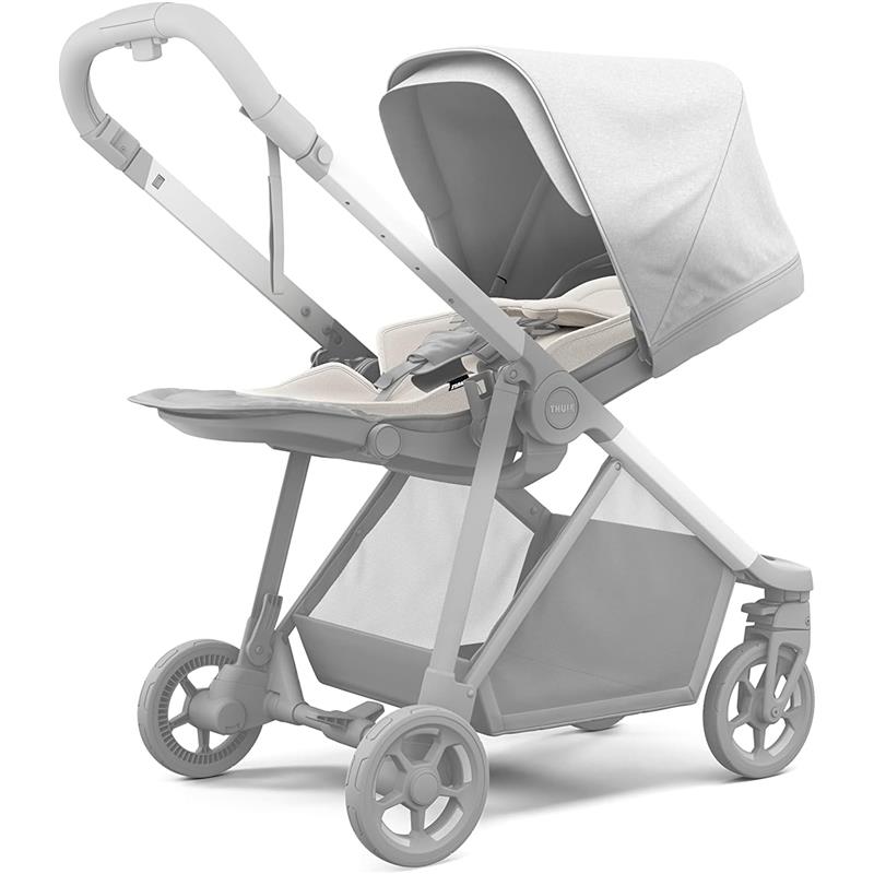 Thule Newborn Inlay, a light gray baby stroller insert with a sun canopy and padded seat, designed for infants.