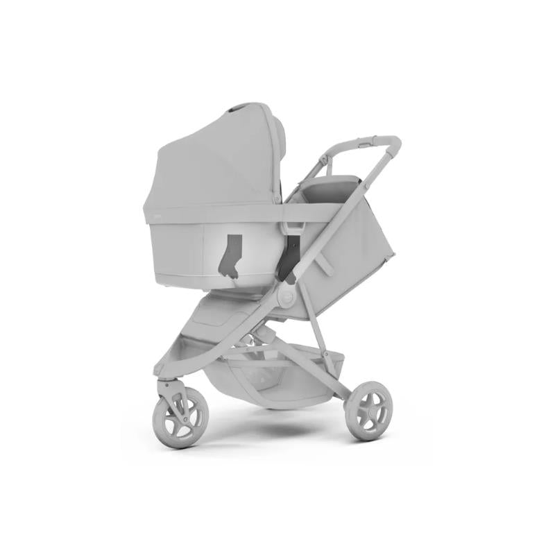 Thule Spring 2 bassinette adapters attached to a stroller, showcasing a sleek design with a sun canopy.
