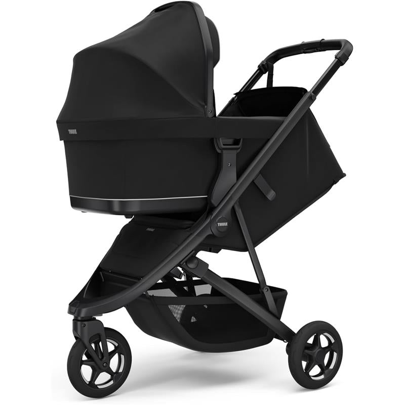 Compact black all-terrain Thule Spring 2 Single Stroller featuring a protective canopy and a spacious storage basket.