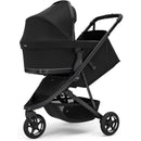 Compact black all-terrain Thule Spring 2 Single Stroller featuring a protective canopy and a spacious storage basket.