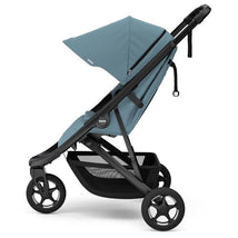 Thule Spring 2 single child stroller in mid blue with an adjustable canopy and sturdy black frame.