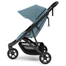 Thule Spring 2 single child stroller in mid blue with an adjustable canopy and sturdy black frame.