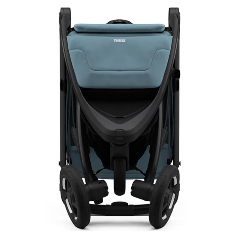 Thule Spring 2 single child stroller in mid blue, featuring a sleek design with a black frame and large wheels.