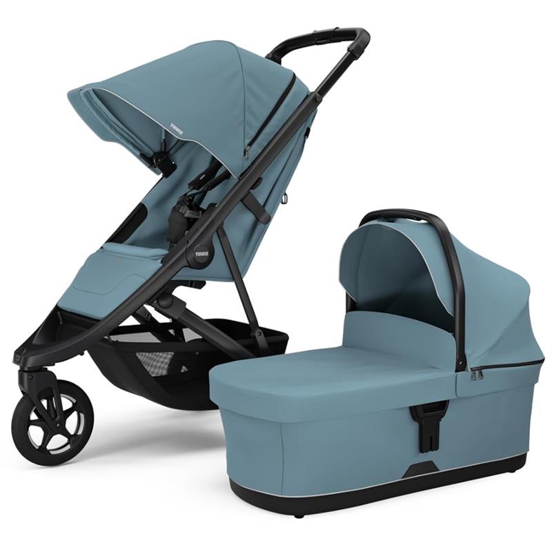 Thule Spring 2 single child stroller in mid blue, featuring a reclining seat and a matching carrycot.