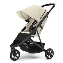 Single child stroller in soft beige with a black frame, featuring a sun canopy and safety harness.