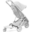 Thule Spring Rider Board Adapter attached to a lightweight stroller, featuring a sturdy platform and wheels for added support.