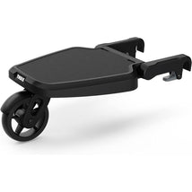 Thule Stroller Rider Board with a black platform and a single wheel for attaching to a stroller, designed for extra child seating.