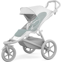 Thule stroller seat liner in Alaska color features a light gray frame and soft aqua padding for added comfort.