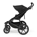 Single child all-terrain stroller in black with a large canopy, featuring four wheels for stability and maneuverability.
