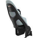 Thule Yepp 2 Maxi Rack Mount child bike seat in light blue and black, featuring adjustable straps and ventilation holes.