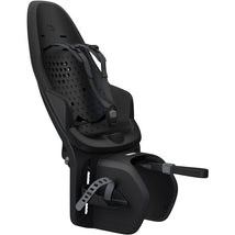 Thule Yepp 2 mounted child bike seat in black, featuring adjustable footrests and a 5-point harness system.