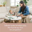 Tiny Love 5-in-1 Here I Grow Activity Center with a baby and parent, featuring playful toys and a modern design in a cozy setting.