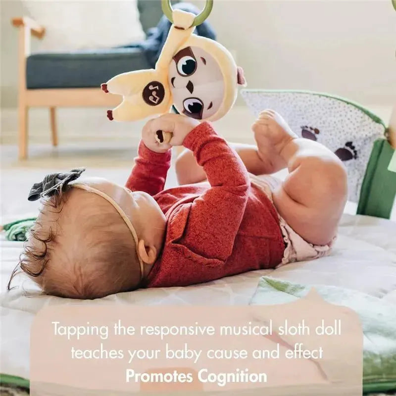 Baby reaches for a musical sloth doll on the Tiny Love Boho Chic Gymini Play Mat, promoting cognitive development.
