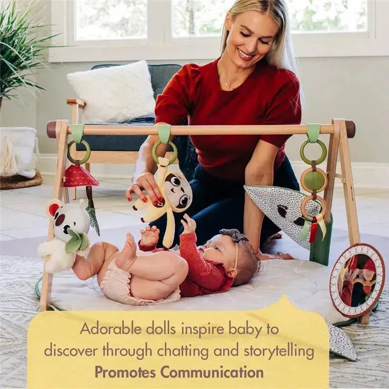 Tiny Love Boho Chic Gymini Play Mat featuring a smiling woman interacting with a baby, surrounded by colorful plush toys.