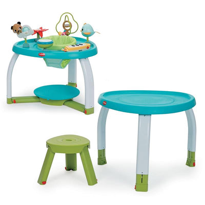 Tiny Love Meadow Days Stationary Activity Center featuring a colorful play table with toys, a cushioned seat, and a small stool.