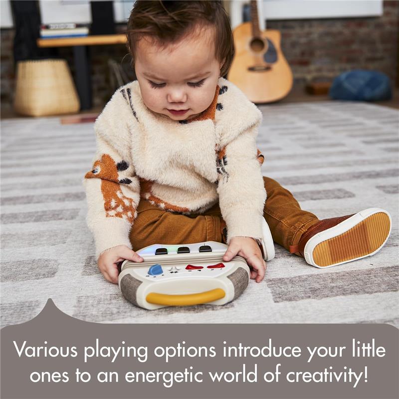 A toddler plays with the Tiny Love Accordion Toy, featuring colorful buttons and a soft, textured design, encouraging creativity.