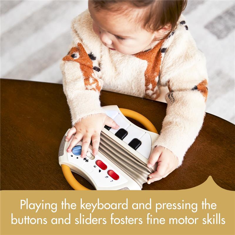 Toddler playing with the Tiny Love Tiny Rockers Accordion Toy, engaging with buttons and sliders to develop fine motor skills.