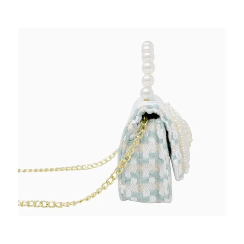 Tweed pearl handle bow purse in blue with a gold chain strap and decorative pearl accents.