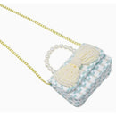 Blue tweed purse with a pearl handle and bow detail, designed for stylish accessory use.