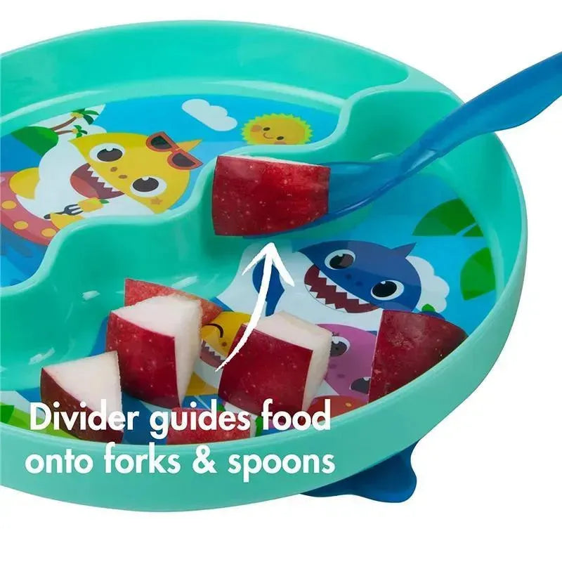 Tomy Baby Shark Groovy Suction Plate features colorful designs and sections, with diced fruit and a spoon assisting in food delivery.