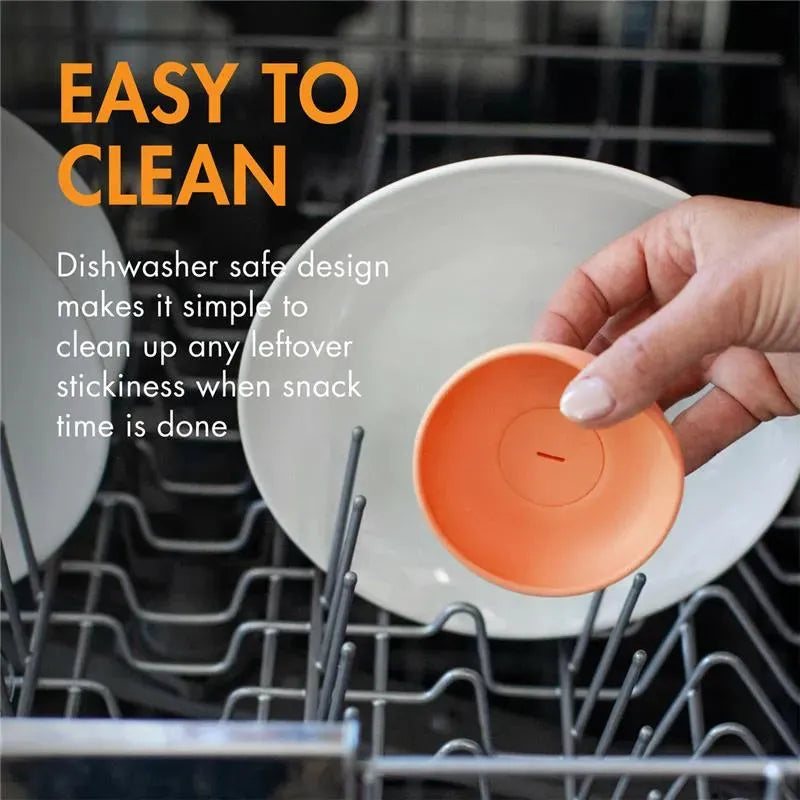 Dishwasher safe Tomy Boon Drizzle Popsicle Holder being cleaned in a dishwasher, highlighting its easy-to-clean feature.