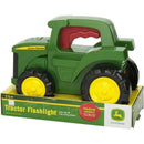 Tomy John Deere Roll N Go Flashlight, a green tractor-shaped toy with rolling wheels and a squeeze handle to activate light.