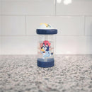 Toddler water bottle with a blue character design, featuring a straw and a floating charm, placed on a countertop.