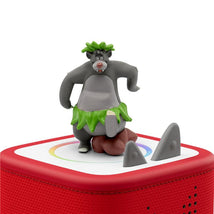 Tonies Baloo Audio Toy Figurine features a smiling bear in a green skirt, standing on a red music box with decorative elements.