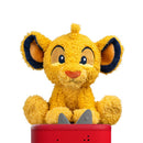 Tonies Cuddle Simba plush toy features a soft, yellow lion cub with a rounded face and large ears, sitting atop a red base.