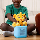 Tonies Cuddle Simba plush toy sits atop a blue audio box, with a child interacting joyfully.