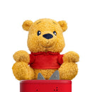Plush Winnie the Pooh toy wearing a red shirt, sitting on a red audio speaker base, designed for storytelling.