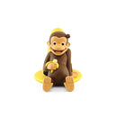 Curious George audio toy figurine, smiling with a banana, sitting on a yellow base.