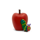 Colorful figurine of a caterpillar next to a large red apple, representing the Tonies The Very Hungry Caterpillar toy.