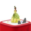 Tonies Tiana audio toy figurine features Tiana in a green and yellow dress atop a red rectangular base with control buttons.