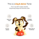 Tonie figurine of a playful brown and cream puppy with a red toy, featuring music and songs for kids in English and French.