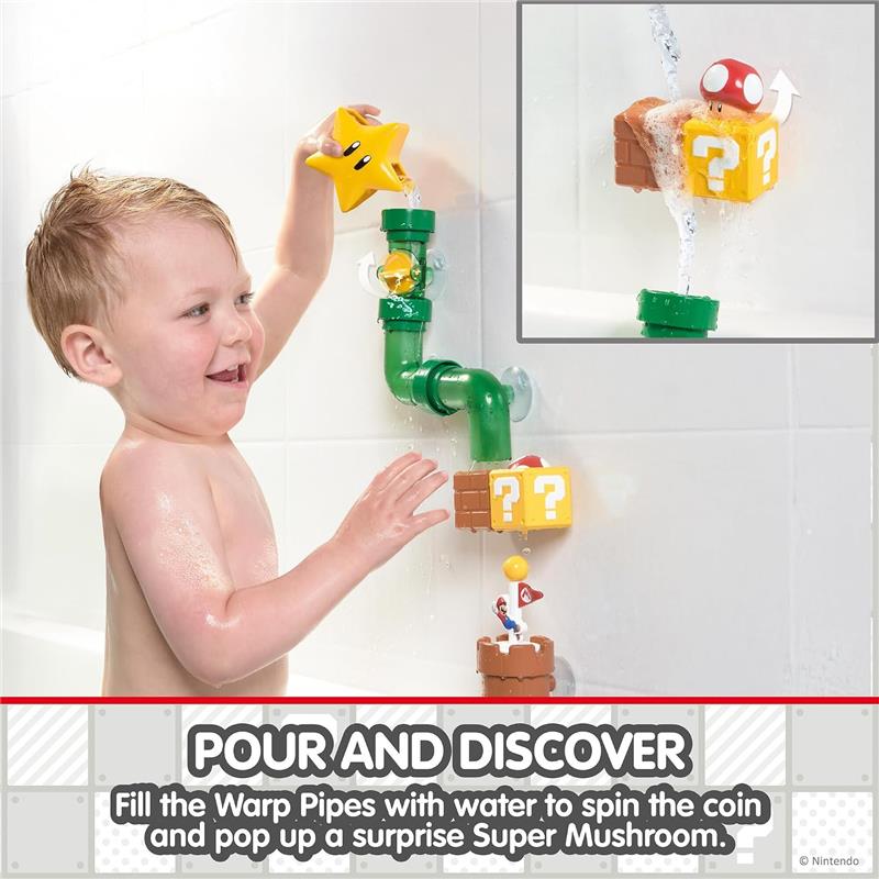 A child is playing with the Toomies My Mario Bath Pipes Playset, pouring water into green pipes, activating colorful blocks with a star, coin, and a Super Mushroom.