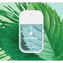 Touchland Frosted Mint Power Mist Hydrating Hand Sanitizer in a clear bottle against green leaves, 1 FL OZ.