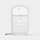 Silicone case for Touchland hand sanitizer mist in icy white, displaying the product name and capacity of 1 fl oz (30 ml).
