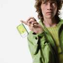 Touchland Hand Sanitizer Mist in a green silicone case with keyring held by a person in a green jacket.