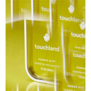 Touchland Vanilla Blossom Power Mist Hydrating Hand Sanitizer in a clear bottle with bright yellow background.
