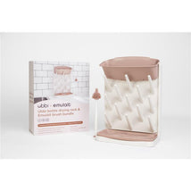Ubbi & Emulait vertical drying rack with a rose-colored top, white drying pegs, and a matching brush, displayed with packaging.