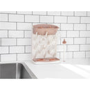 Vertical drying rack with clear bottles and an upper holder, set against a white tiled background.