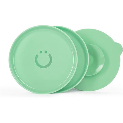 Set of two green Ubbi plates with interchangeable suction bases, featuring a smiley face design on each plate.