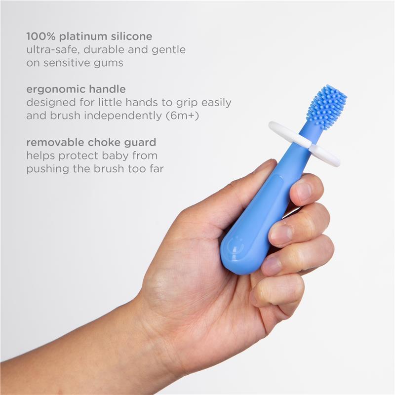Toddler toothbrush set featuring a blue, silicone brush with an ergonomic handle and removable choke guard for safety.