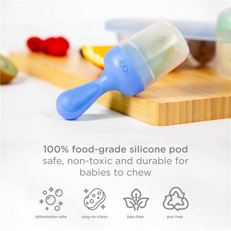 Ubbi Smoothie Purple Baby Food Feeder with a silicone pod on a wooden surface, showcasing fruit and key product features.