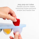 Silicone feeder and freezer tray set showing easy pop-out cubes; a hand removes a frozen fruit portion.