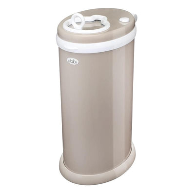 Taupe Ubbi stainless steel diaper pail with a white locking lid and a top opening, designed for odor containment without special bags.