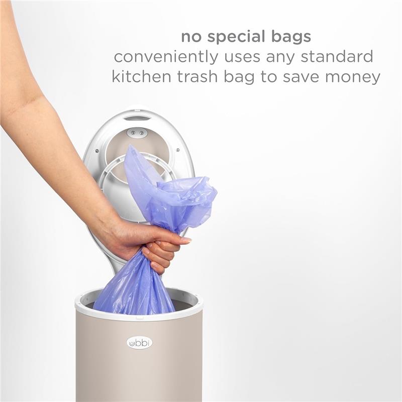 Ubbi stainless steel diaper pail in taupe, demonstrating use with a blue kitchen trash bag, highlighting no special bag requirement.
