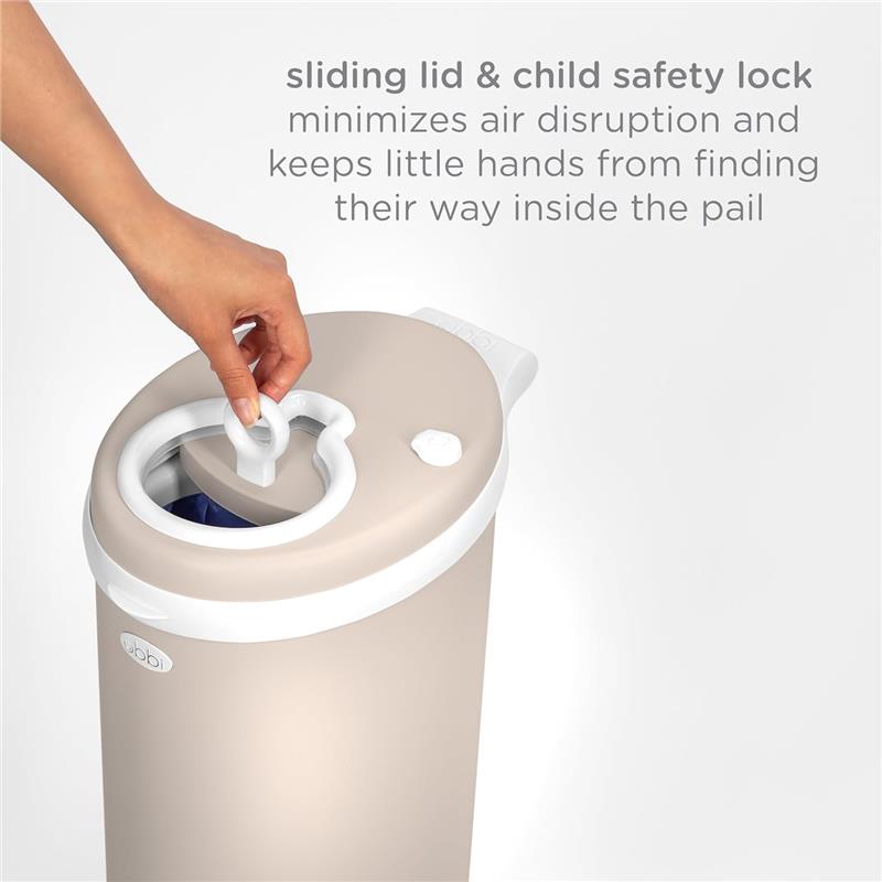 Taupe Ubbi stainless steel diaper pail with a sliding lid and child safety lock, designed to minimize odor and air disruption.